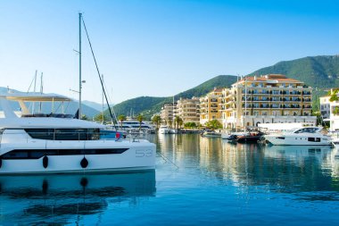 Tivat, Montenegro - June 28, 2022: Sunset view of the yacht marina in Porto Montenegro with waterfront residences and  the beautiful promenade