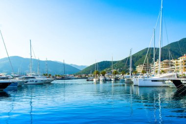 Tivat, Montenegro - June 18, 2022: Sunset landscape of the yacht marina in Porto Montenegro with waterfront residences and  the beautiful promenade