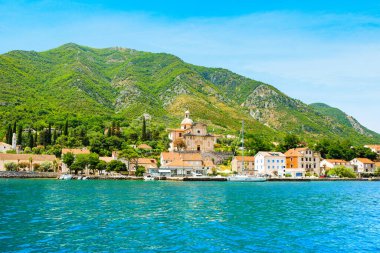 Prcanj, Montenegro - june 28, 2022: Panoramic landscape of the the historic town of Prcanj on the shore of Bay of Kotor, with view to Church of the Nativity of the Blessed Virgin Mary, Montenegro 