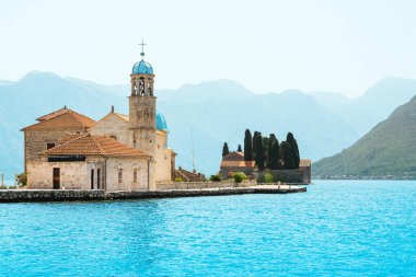 Sunset landscape of the Bay of Kotor coastline - Boka Bay with view to the Roman Catholic Church of Our Lady of the Rocks and Saint George Benedictine monastery on the islands,  Montenegro
