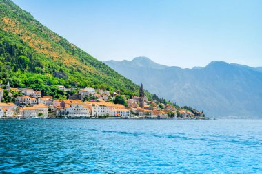 Perast, Montenegro - May 28, 2022: Beautiful sunset landscape with the historic town of Perast on the shore of the Boka Bay - Bay of Kotor, Montenegro 