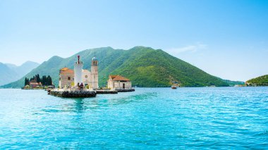 Perast, Montenegro - May 28, 2022: Panoramic landscape of the Bay of Kotor coastline - Boka Bay with view to the Roman Catholic Church of Our Lady of the Rocks and Saint George Benedictine monastery 