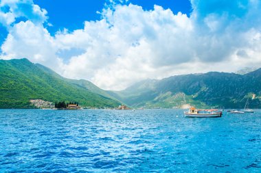 Perast, Montenegro - May 28, 2022: Landscape of the Bay of Kotor coastline - Boka Bay with view to the Roman Catholic Church of Our Lady of the Rocks and Saint George Benedictine monastery