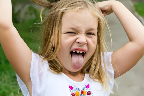 Girl makes faces imitate witch — Stock Photo, Image