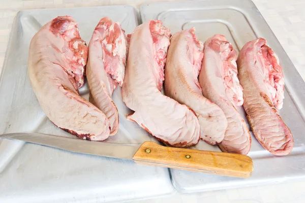 Raw pork tongue with knife — Stock Photo, Image