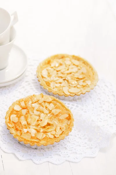 Almond tarts on wooden white table — Stock Photo, Image