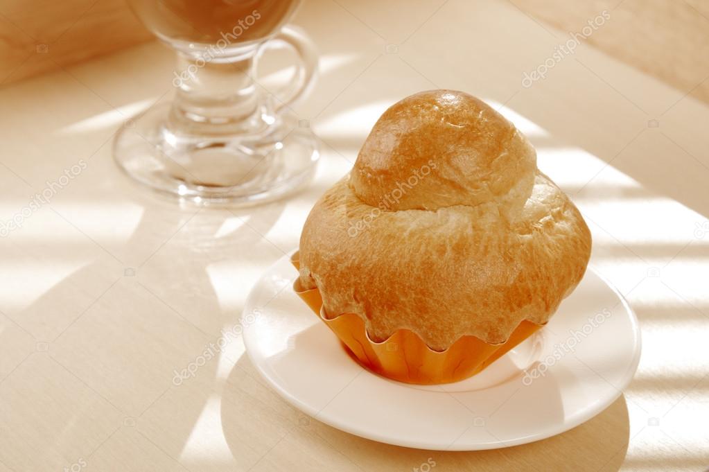 French Brioche and white cup of Coffee on background