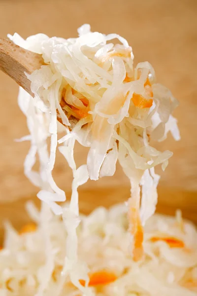 Sour cabbage - sauerkraut - on wooden spoon — Stock Photo, Image