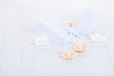 paper butterfly and three sugar blossom flowers on white old tab clipart