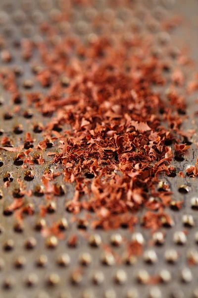 Fine grated chocolate on grater , shallow dof — Stock Photo, Image