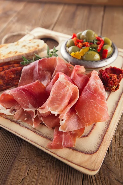 Tallrik av serrano jamon botade kött, ciabatta, chorizo och Oliver — Stockfoto