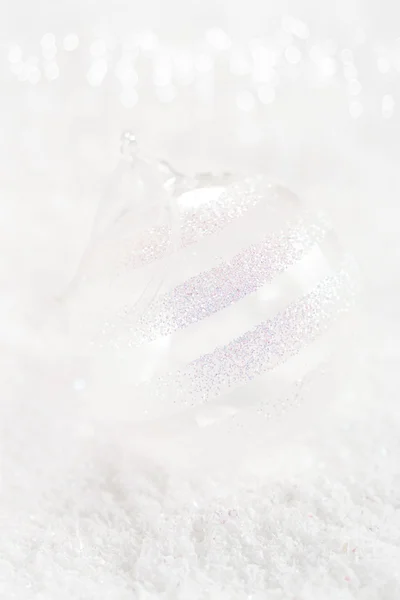 Clear glass ball christmas decoration on white snow background — Stock Photo, Image