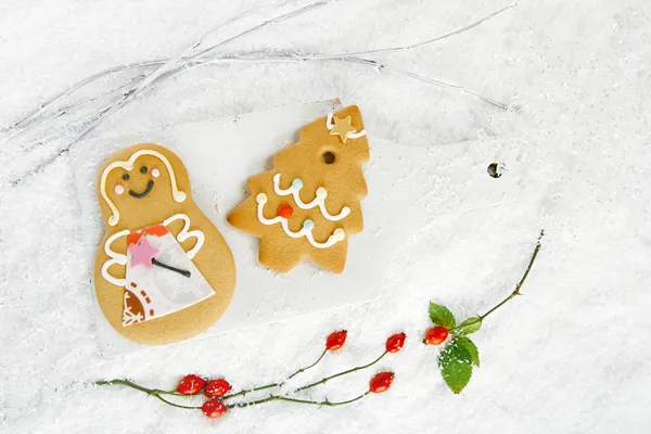 Gingerbread tree and girl cookies on white wood and snow backgr — Stock Photo, Image