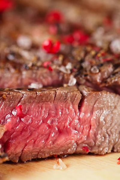 Beef steak on a wooden board and table — Stock Photo, Image