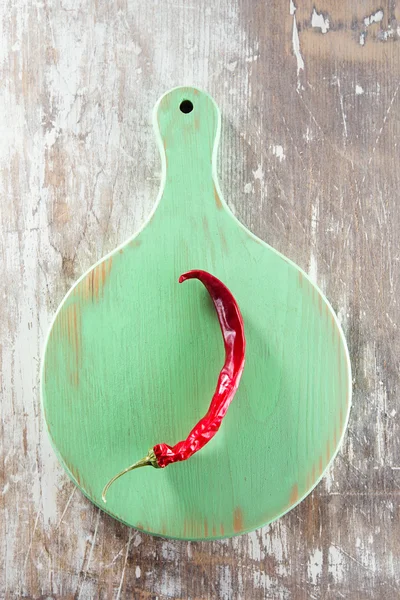 Chiles rojos sobre tabla de madera verde — Foto de Stock