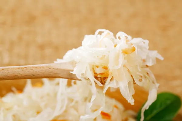 Sour cabbage - sauerkraut - on wooden spoon — Stock Image Sour cabbage - sauerkraut - on wooden spoon Stock Image