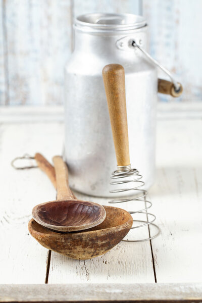 retro kitchen utensils tools on old wooden table in rustic style