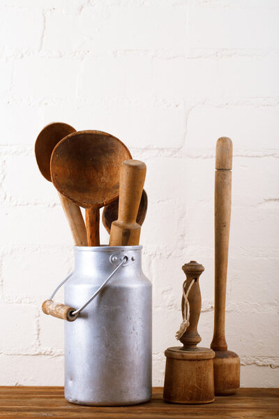 retro kitchen utensils tools on old wooden table in rustic style