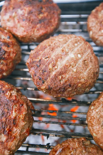 Food meat - beef burgers on bbq barbecue grill with flame — Stock Photo, Image