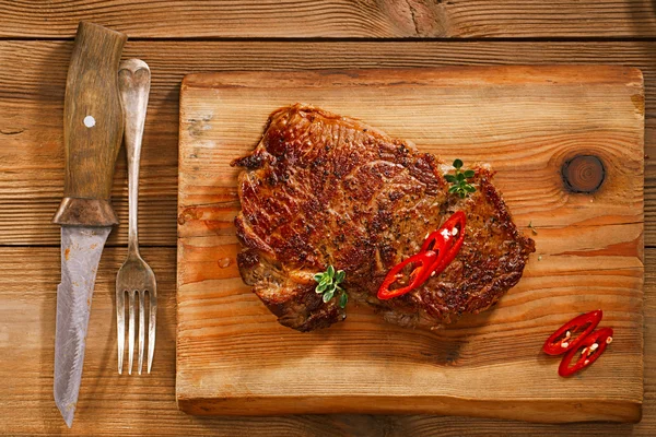 Beef steak on wood and table — Stock Photo, Image