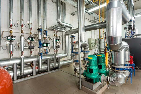 Interior gas boiler room with multiple pumps and piping — Stock Photo, Image