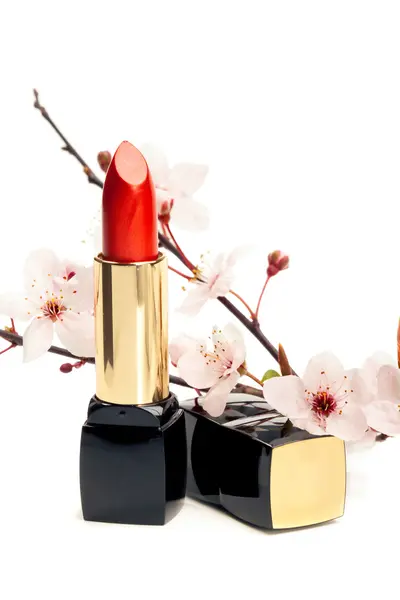 Natural cosmetics concept: new lipstick with sakura flowers, iso — Stock Photo, Image