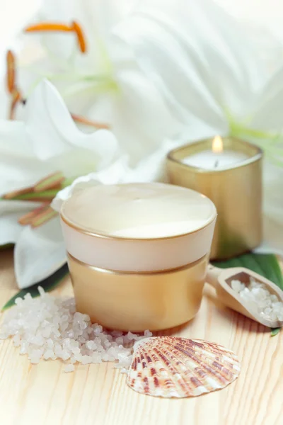 Moisturizing face cream with candle and white lily flowers, clos — Stock Photo, Image