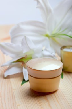 yüz bakımı ve spa konsept - yüz kremi ve lily çiçekler, portre