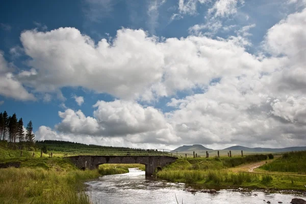 Countryside landscape image across to mountains in distance with — Stock Photo, Image