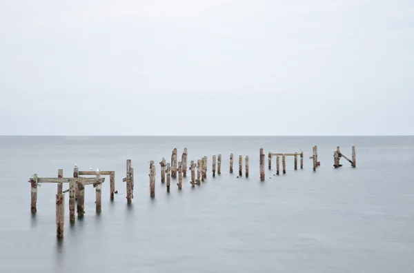 Long exposure derelict pier in calm sea