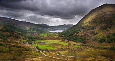 Landscape through valley to Llyn Dinas in Snowdonia National Par clipart
