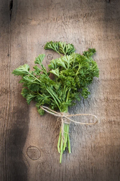 Fresh parsley on vintage wooden board — Stock Photo, Image