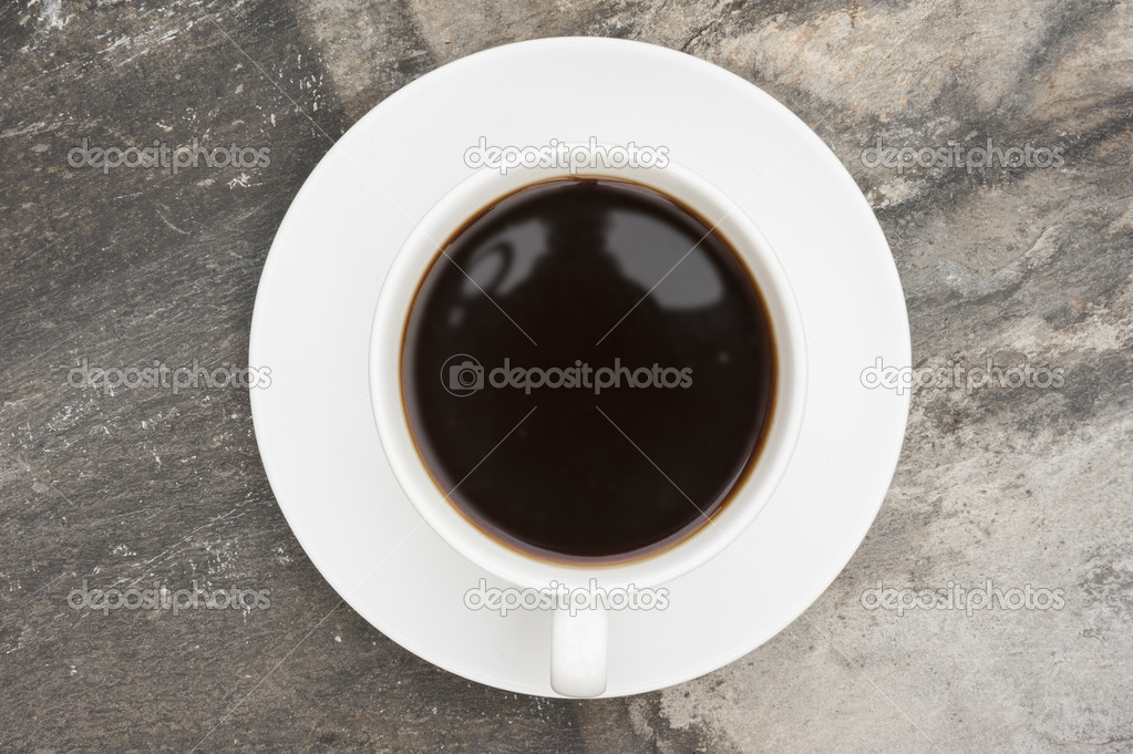 Coffee cup and saucer on slate rustic background