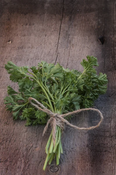 Fresh parsley on vintage wooden board — Stock Photo, Image