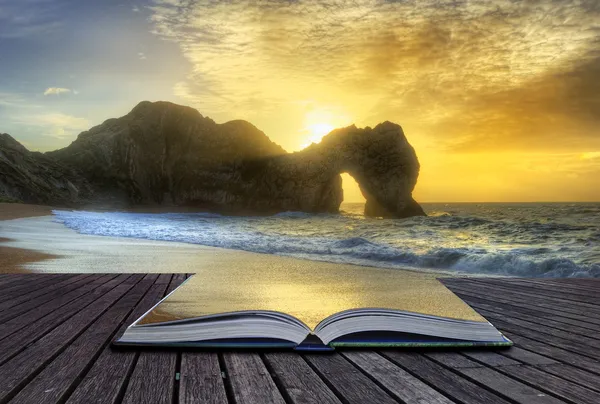 Vibrant sunrise over ocean with rock stack in foreground in page — Stock Photo, Image