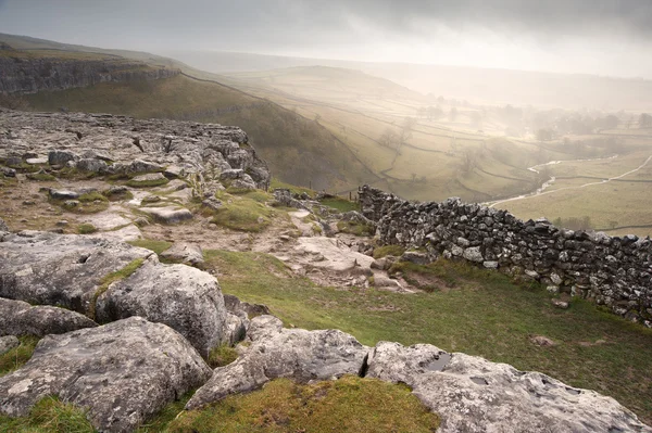 View of misty Malham Dales from limestone pavement above Malham — Stock Photo, Image