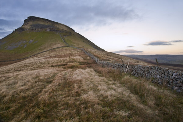 Stone wall running up height of Pen-y-Ghent in Yorkshire Dales N
