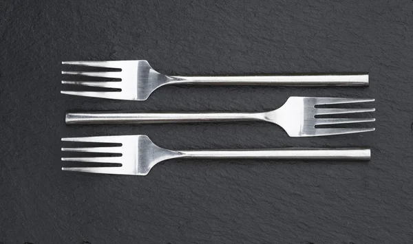 Macro imagen de tenedores de cubiertos sobre fondo rústico — Foto de Stock