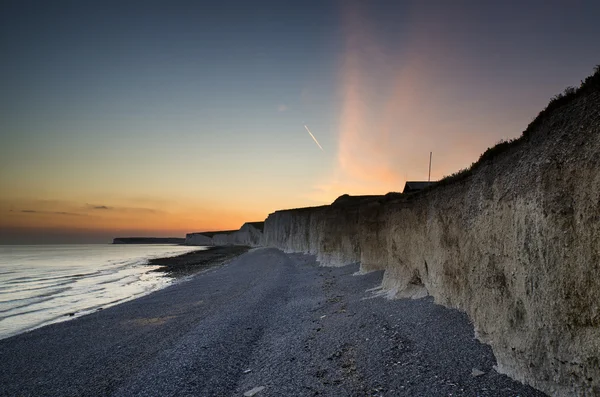 Long exposure landscape rocky shoreline at sunset — Stock Photo, Image