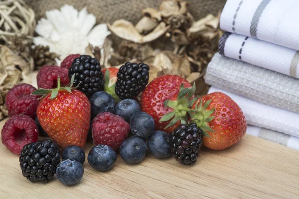 Fresh Summer berries in rustic kitchen setting — Stock Photo, Image