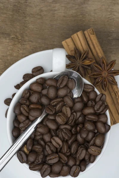 Tasse de café et haricots sur fond en bois — Photo