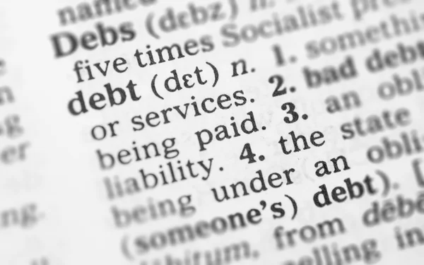 Macro image of dictionary definition of debt — Stock Photo, Image