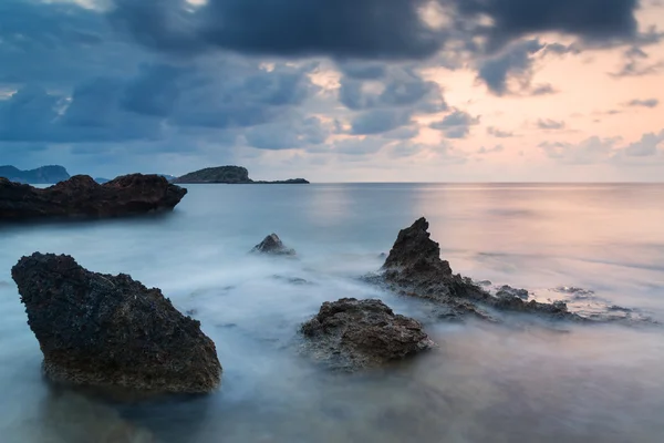 Stunning landscape dawn sunrise with rocky coastline and long exp — Stock Photo, Image