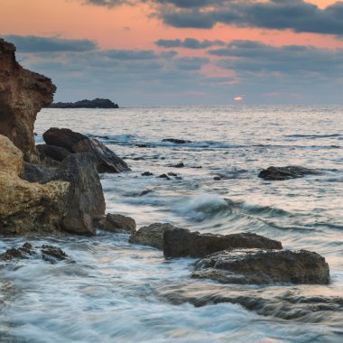 Stunning landscapedawn sunrise with rocky coastline and long exp