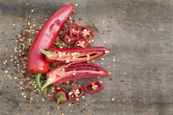 Red cayenne chili peppers on wooden background — Stock Photo, Image