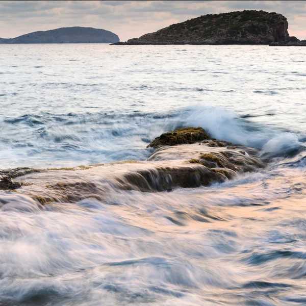 Stunning landscape dawn sunrise with rocky coastline and long exp — Stockfoto