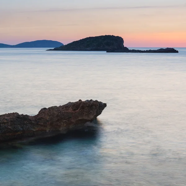 Stunning landscape dawn sunrise with rocky coastline and long exp — Stockfoto