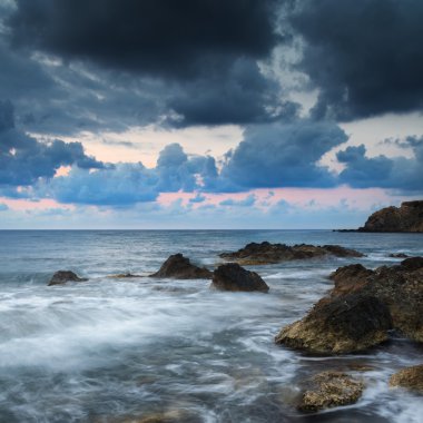 Stunning landscapedawn sunrise with rocky coastline and long exp