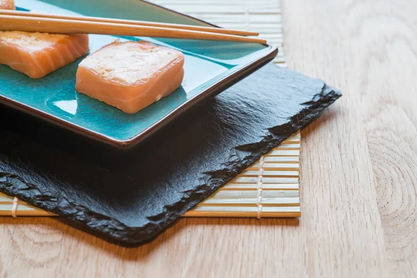 Fresh sushi salmon cream cheese parcels on plate with chopsticks — Stock Photo, Image