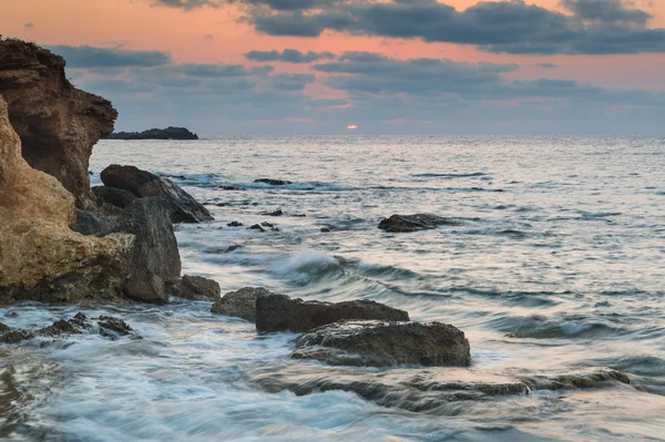 Landscape seascape of jagged and rugged rocks on coastline with — Stock Photo, Image